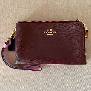 Coach wristlet with two zippers and card holder.